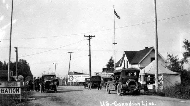 The US-Canada border at the Pacific Highway crossing as seen in 1921. Cross-border parcel delivery between the US and Canada, customs and carriers