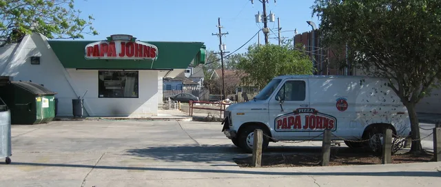 New Orleans after Hurricane Katrina : Calhoun Street at Miro, back from Clairborne, Uptown. Flooded out Papa John's Pizza delivery restaurant and delivery truck. Note lines from various level of long standing floodwater seen on side of the van. 3 hurricane season delivery steps for Gulf Coast couriers