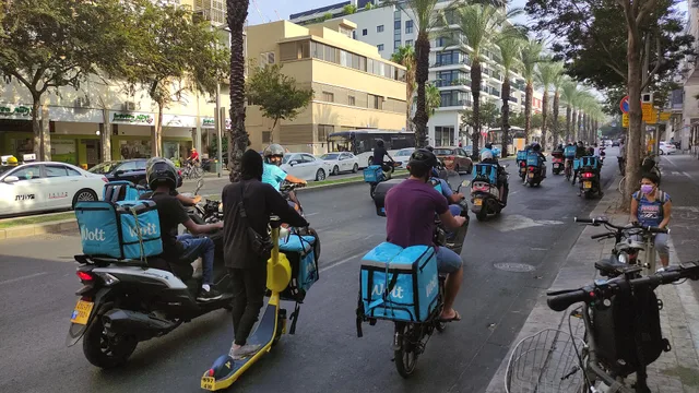 Wolt delivery drivers driving together in Tel Aviv in portest aginst changes in the contract with the company. Local delivery contract terms: the parts worth your attention