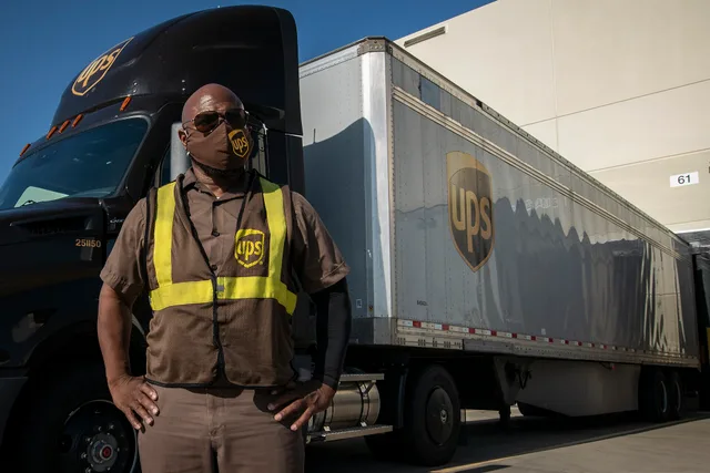 UPS feeder driver Birrill Taylor outside his assighed new diesel tractor that he uses to deliver and pick up trailers from local customers and 'feeds' the UPS Lone Star distribution center (hub), in Arlington, TX, on August 14, 2020. Today, he picked up a trailer full of these boxes from Pro Pac Qua. How Local Delivery Operations Work