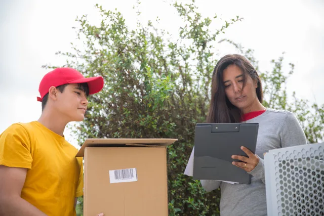 Courier delivering a package while a woman signs a form outdoors. Parcel Lastmile Resale: Terms to Check Before You Sign